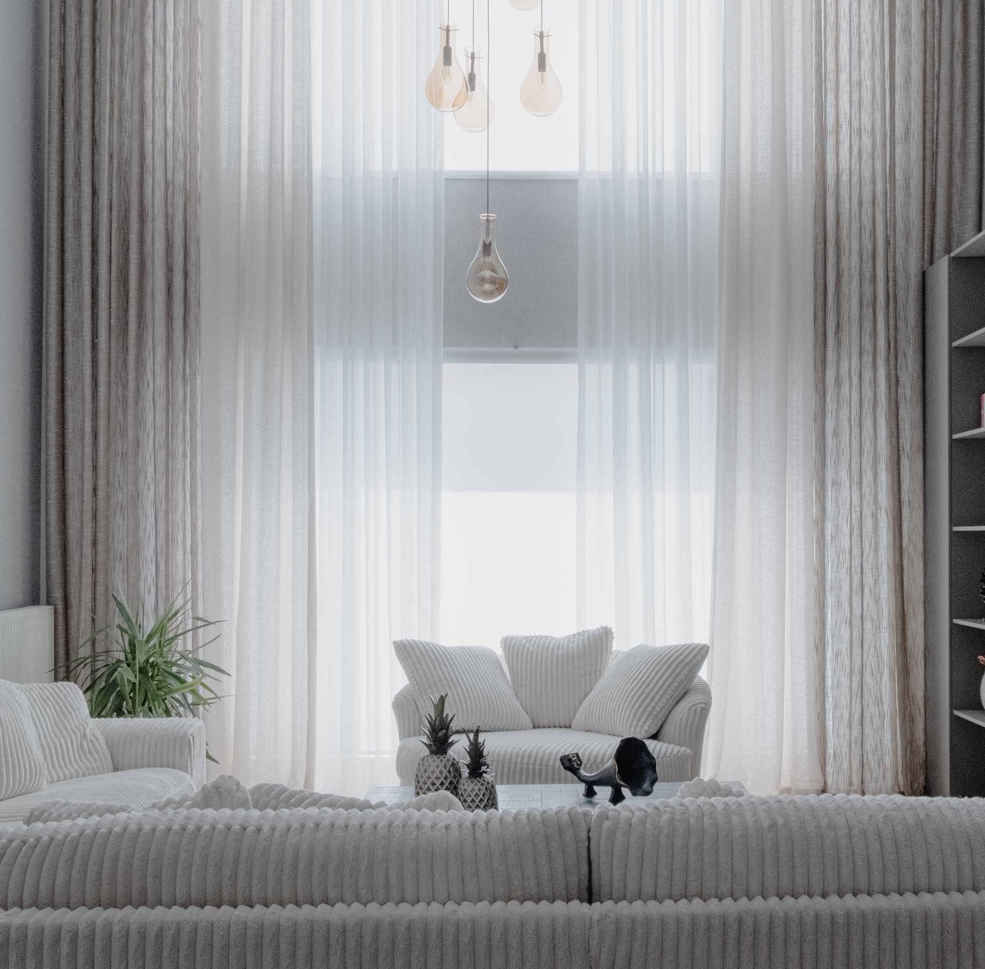 Bright, clean living room with sheer curtains